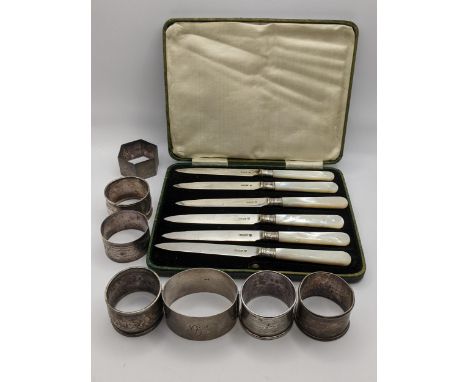 Six late 19th/early 20th century silver napkin rings and a silver bangle 150.7g, together with a cased set of silver and moth