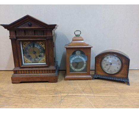 An early 20th Century walnut cased mantle clock, an early 20th Century oak cased example and a Rotherham's walnut cased clock