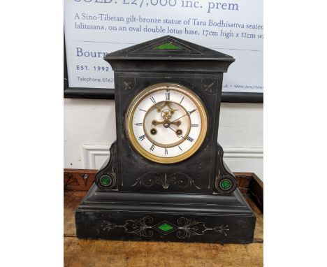 A Victorian black slate mantle clock having a visible Brocot escapement and striking on a bell 