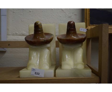 PAIR OF POLISHED ALABASTER BOOKENDS FORMED AS FIGURES IN MEXICAN HATS