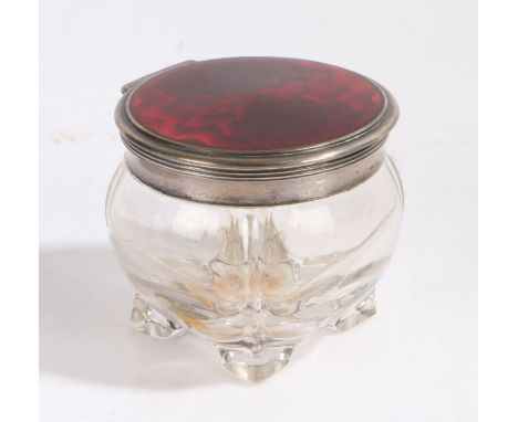 Continental white metal and enamel dressing table pot, the hinged circular lid with red enamel decoration, the ridged bulbous