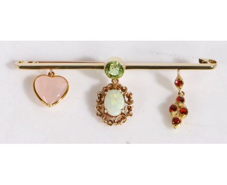 A delightful 15 carat gold and multi-gem bar brooch, having a round cut peridot to the centre of the bar, suspending an opal 