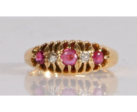 18 carat gold ruby and diamond ring, the head set with three round cut rubies with two intersecting diamonds, ring size O wei