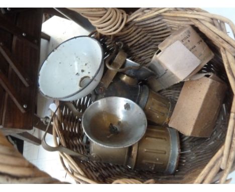 A pair of vintage miners lamps with a wicker basket