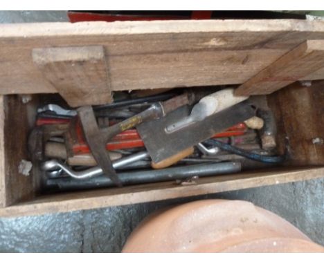 A vintage wooden explosives box with a selection of vintage tools within