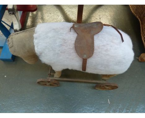 A vintage child's ride on pony with leather saddle