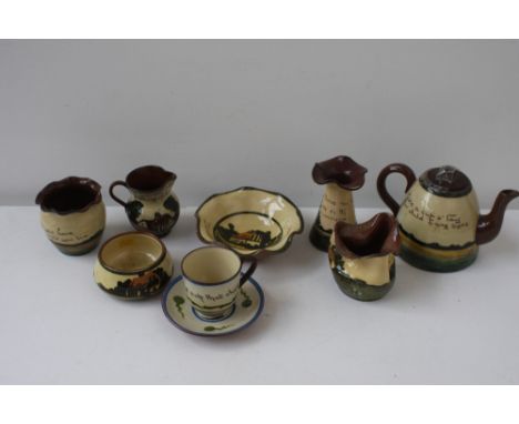 A quantity of Crown Dorset Pottery mottoware to include a teapot (damage) various poesy vases, jugs and dishes (8)