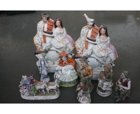 Two Staffordshire style flat back figurines of a seated couple over a hand painted clock (one with damage to head of male fig