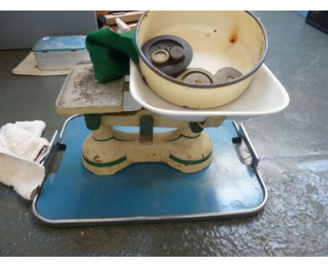 A set of vintage kitchen scales, with weights and a tray
