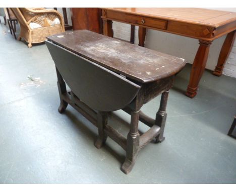 A 17th century gate leg table, on turned supports and splayed feet, 105cm