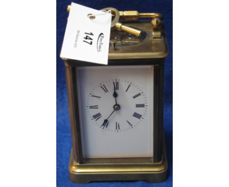 Early 20th Century brass carriage clock with full depth enamel dial and repeating movement, striking on one gong.  With key.