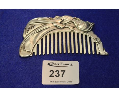 White metal oriental design comb with female figure decoration. CONDITION REPORT: No obvious damage.  Length 9½cm