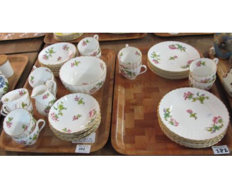 Two trays of late 19th / Early 20th Century Coalport china tea and other items on a white ground with gilt banding and floral