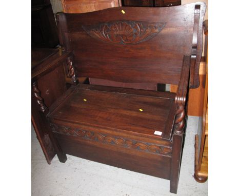 Reproduction oak carved Monk's bench with barley twist supports.