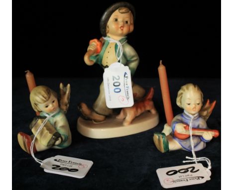 Goebel Hummel figure of young boy with dog, together with pair of Goebel Hummel cherub candle sticks, playing instruments.  (
