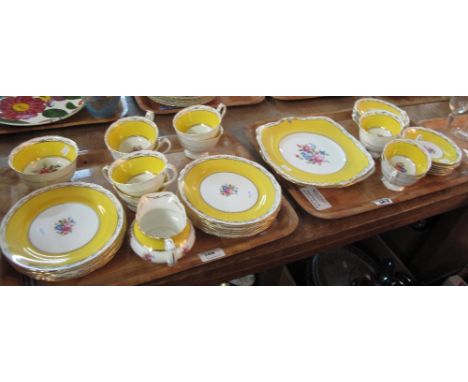 Two trays of Paragon fine bone china tea ware items on a white and yellow ground with floral decoration comprising tea cups, 