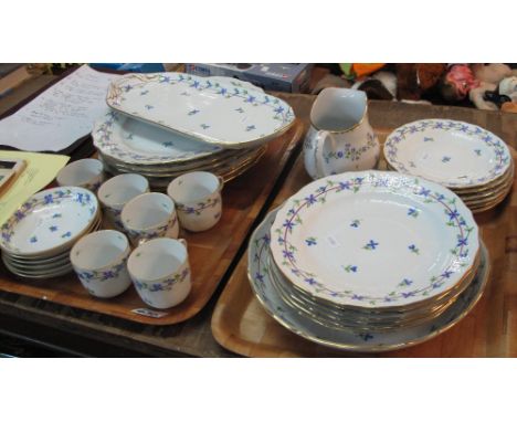 Two trays of hand painted continental tea and dinner ware items on a white ground with floral decoration comprising cups, sau