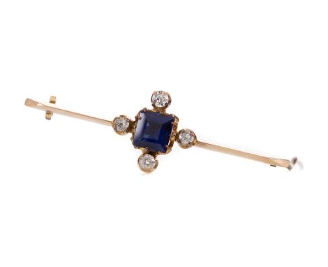 BLUE PASTE AND DIAMOND BAR BROOCH,set with a step cut blue paste flanked by three old cut diamonds and one clear paste stone,