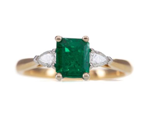 EMERALD AND DIAMOND THREE STONE RING,set with an emerald of approximately 0.85 carats, flanked by pear shaped diamonds totall