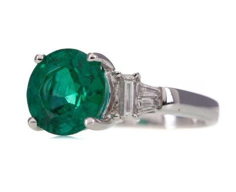 IMPRESSIVE EMERALD AND DIAMOND RING,set with a round emerald of approximately 3.19 carats, flanked by baguette cut diamonds t