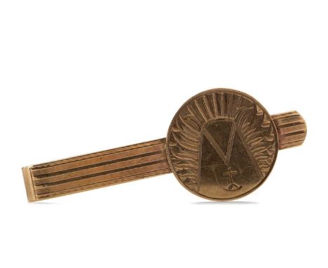NINE CARAT GOLD TIE SLIDE,the bar with engine turned decoration and overlaid engraved disc, 8.1g