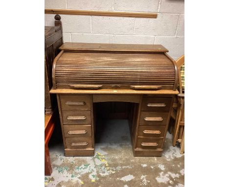 1920s light oak twin pedestal roll-top desk enclosed by tambour shutter with six drawers, 106cm wide, 68cm deep, 102cm high, 