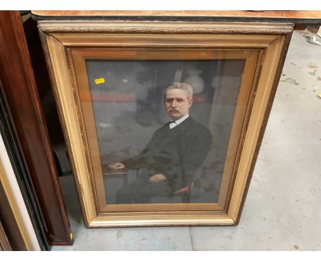 Early 20th century overpainted portrait photograph of a man in glazed gilt frame.