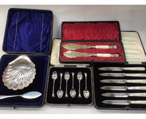 Silver shell butter dish and knife, set of six silver coffee spoons, set of six silver and mother of pearl fruit knives and a
