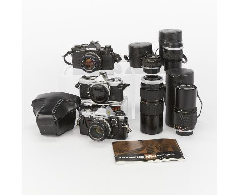 Group of three Olympus cameras and four lenses - three cameras and four lenses - including:One 35mm OM-1 camera with serial n