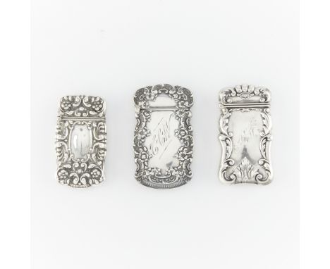 Three sterling silver vesta cases. One engraved CCW and with foliate repousse designs, marked sterling along the lip. One eng