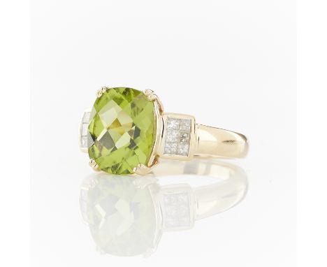 14k yellow ring set with an oval checkboard cut peridot with rectangles of six princess cut diamonds on either side. Marked 1