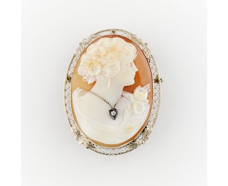 Shell cameo habille brooch set with a single cut diamond, in a 14k white gold filigree frame. With hidden bale and locking sa