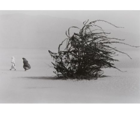 Sebastiao Salgado (Brazilian, b. 1944). Gelatin silver print photograph titled "Soudan" depicting a barren landscape with two