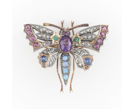 Late Victorian (ca. 1880) butterfly brooch in 14k gold and silver, set with 24 rose cut diamonds, eight rubies and two sapphi