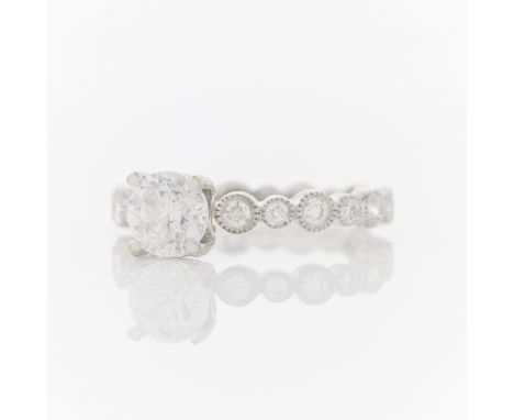 18k white gold ring with diamond set band consisting of 12 brilliant cut diamonds of alternating sizes, G to H color, SI1-SI2