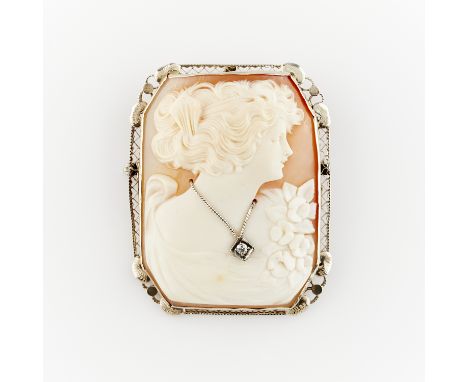Shell cameo habille brooch set with single cut diamond, in 14k white gold filigree frame. With hidden bale and locking safety