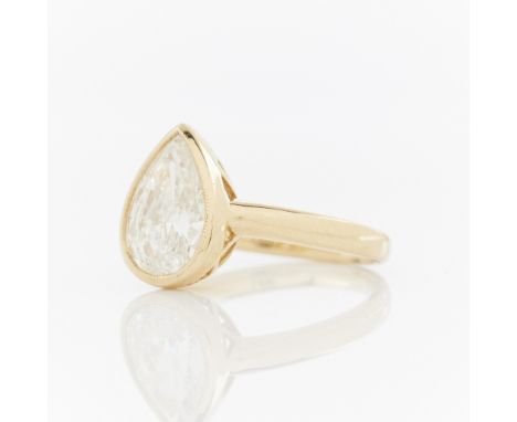 18k yellow gold ring with a bezel set pear diamond. The bezel with fine milgrain detail and set with a 2.02 ct pear cut diamo
