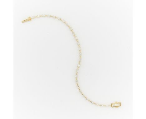 Oscar Friedman 18k yellow gold baguette cut diamond bracelet. Set with 30 step cut diamonds, 27 step cut diamonds set in four