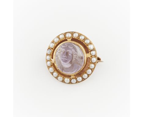 14k yellow gold brooch set with central amethyst cameo, carved to depict a bust of a classical veiled woman. Surrounded by 22