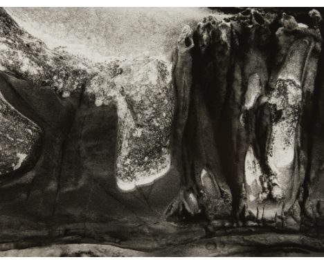 Jack Welpott (American, 1923-2007). Gelatin silver print photograph titled "Pebble Beach" depicting an abstracted view of roc