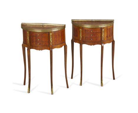 Pair of French empire style demilune or half-round wooden side tables with gilt metal accents and brass top frames. Each with