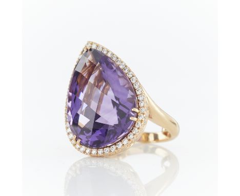 14k yellow gold cocktail ring set with large checkerboard cut pear cut amethyst (calculate carat weight) surrounded by a halo