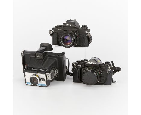 Group of three vintage cameras including:One Canon F-1 35mm film camera with a 50mm lens. The body with serial number 163998.