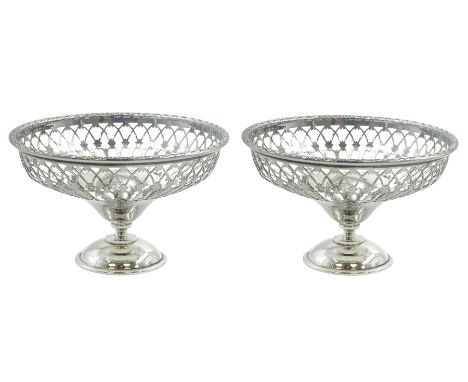 Pair of early 20th century small silver openwork footed bowls, of part pierced circular form upon domed circular feet, hallma