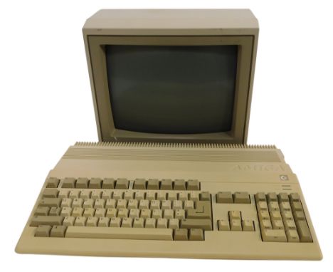 A Commodore Amiga model 500 keyboard, with monitor.