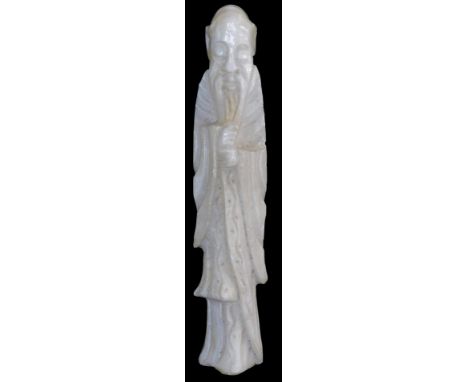 A 20thC Oriental hardstone carving, depicting a sage, with hands clasped, wearing a cloak, 30cm high. 