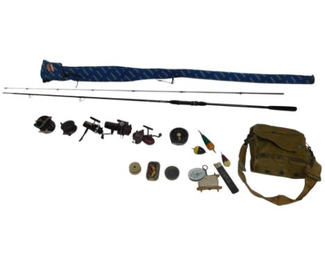A Khaki fishing bag, containing lures, floats, and reels, including a Winfield trout fly wheel, Penn No. 79 fixed reel, a Sha