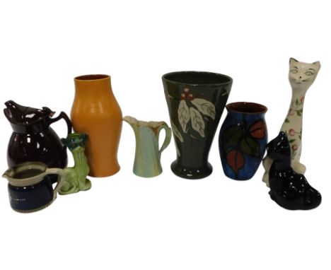 A group of Torquay ware pottery, to include a Brannam pale orange glazed vase, various pottery cats, a Royal Worcester leaf m