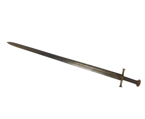 A 19thC Sudanese Kaskara sword, with circular leather covered pommel, banded leather hand grip, brass hilt, the blade decorat