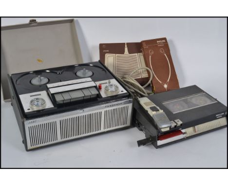 A vintage reel to reel tape recorder along with a retro dictaphone recording machine with foot pedal and headphones